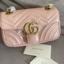 Soft pastel color GG brand Mamont flip-top bag, with vintage gold hardware and checkered pattern quilted leather crossbody bag