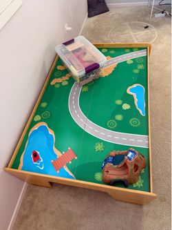 Kidkraft train table with train blocks and red tubs