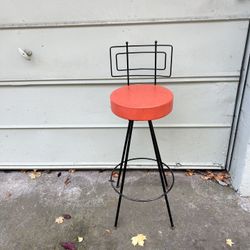 mid-century modern Frederic Weinberg-style bar stool featuring a black iron frame and a round cushioned Swivel seat