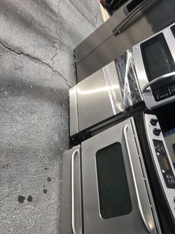 Stainless steel kitchen appliance set with slide in