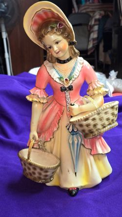 Vintage Tall Portuguese Porcelain or Figurine in a Victorian  Style, depicting an elegant lady in a pink and yellow dress holding baskets and an umbre