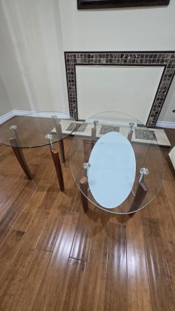 A glass coffee table and an end table