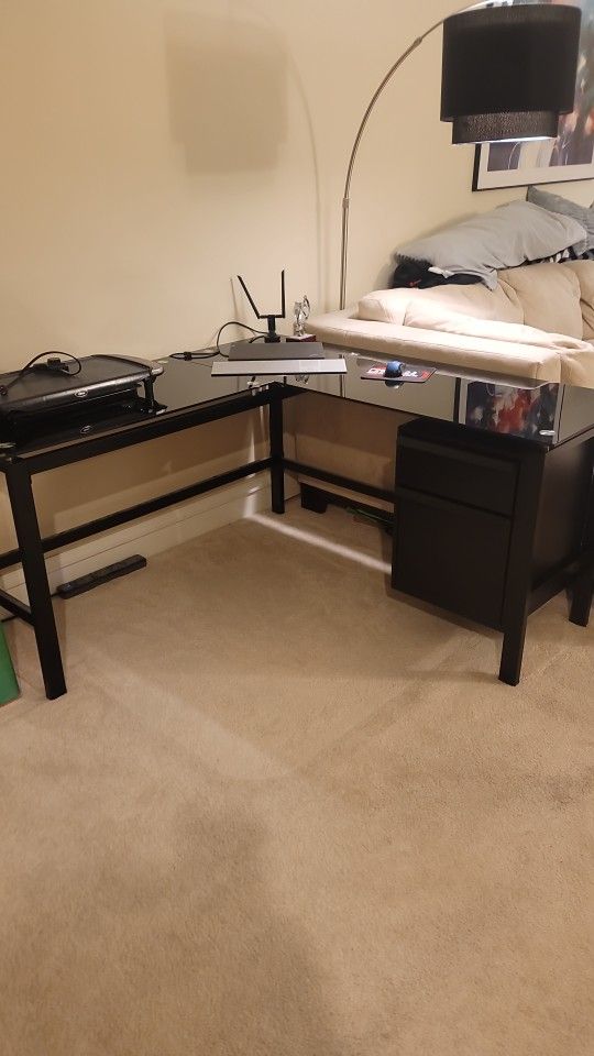 L-Shaped Glass Top Desk With 1 Desk Drawer & 1 File Drawer. 4'-8" X 4'-8"