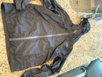 Black north face rain jacket. Size: youth large