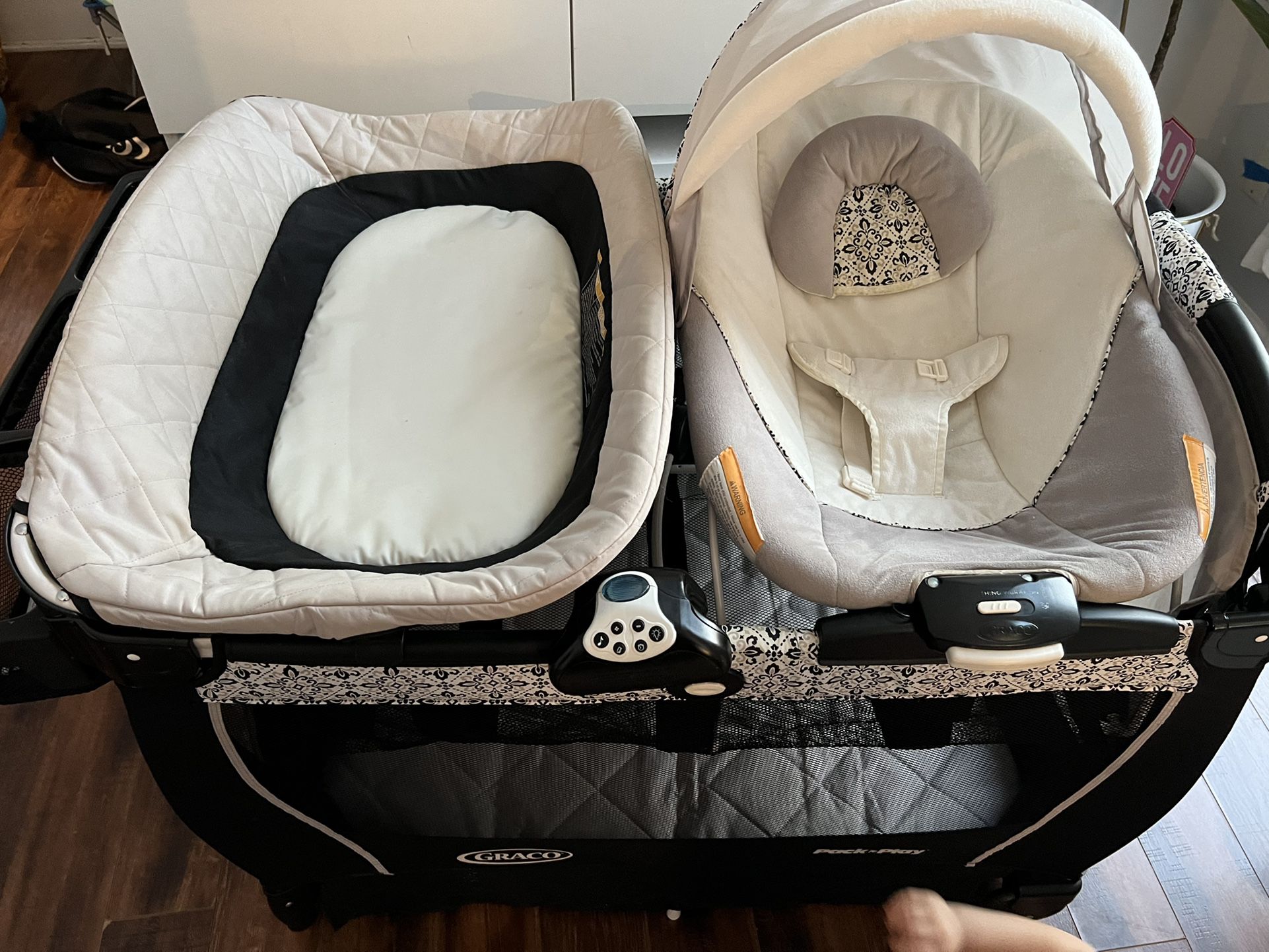 Pack and play with diaper change her bassinet sound machine to separate levels and diaper storage