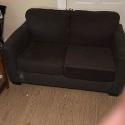 Long black pullout bed, couch, and small, matching couch