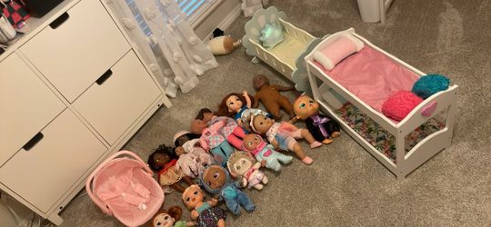 Grouping of dolls and doll bed n cradle