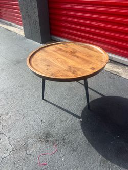 Benedict Jay Solid Wood Round Side Table features a natural mango wood finish paired with a splayed black metal base.
