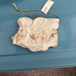 white porcelain angel ornament featuring delicate gold-tone accents and sculpted detailing.