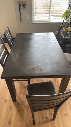 Dark gray brown Wood Dining Table with 4 Chairs heavily used