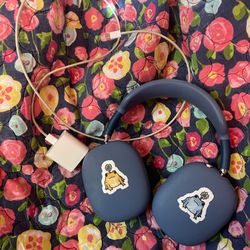 Blue Airpod Pro Max’s with charger, silicone case, and stickers