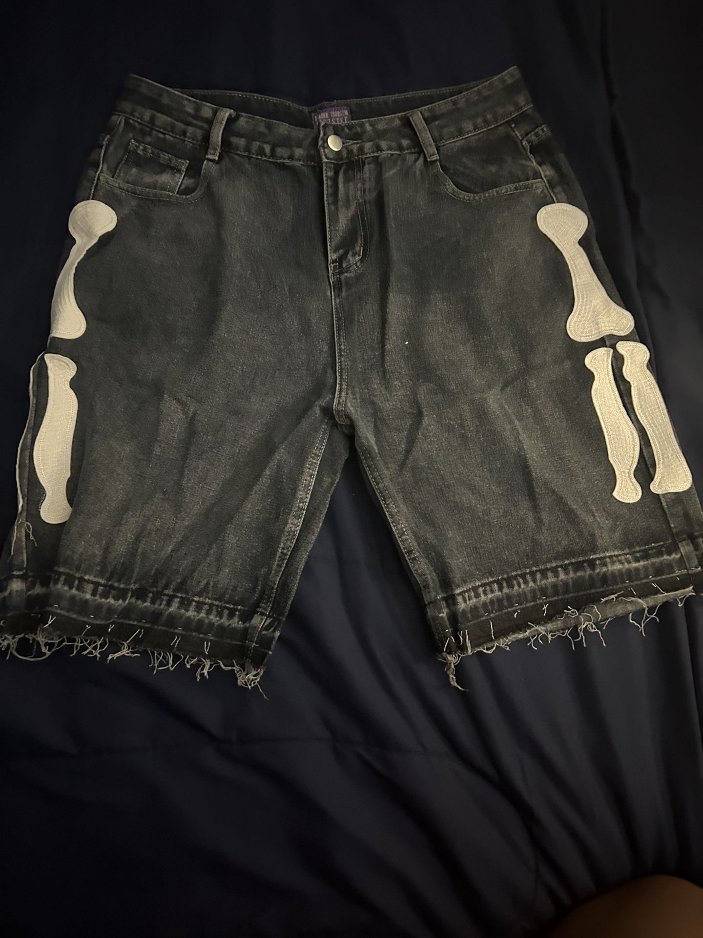 Black denim shorts with white skeleton design