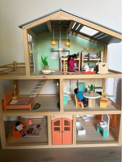 Fully assembled dollhouse with dolls and furniture