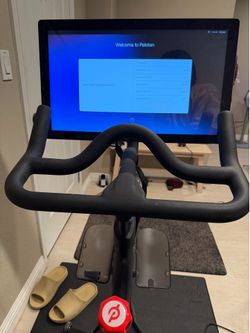 Peloton exercise bike w/ 2 pair of cycling shoes