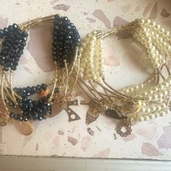 Stainless steel, gold age bracelet. Has seven tiny bracelets.