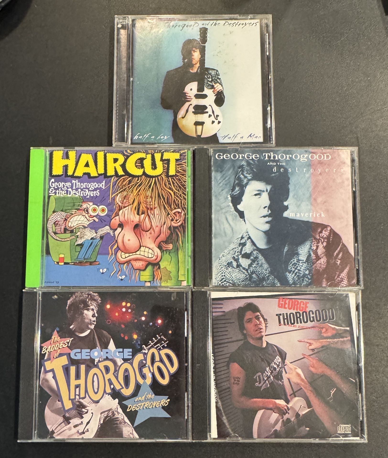 George Thorogood & The Destroyers 5 CD Lot, Born To Be Bad, Haircut, Maverick, The Baddest, & Half a Boy Half a Man. The cds are in good condition.
