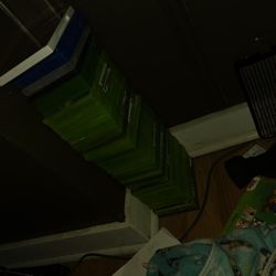 A Bunch Of Xbox 360 Games In Case With The Books Inside 