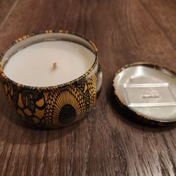 New Voluspa Baltic Amber Mini Tin Candle. 
It contains a proprietary coconut wax blend and 100% natural wick, scent iamber resin, 