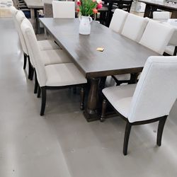 Dining set featuring a large rectangular dark wood table paired with six