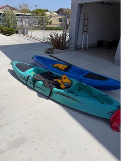 Pair of Cobra sit-on-top kayaks with paddles