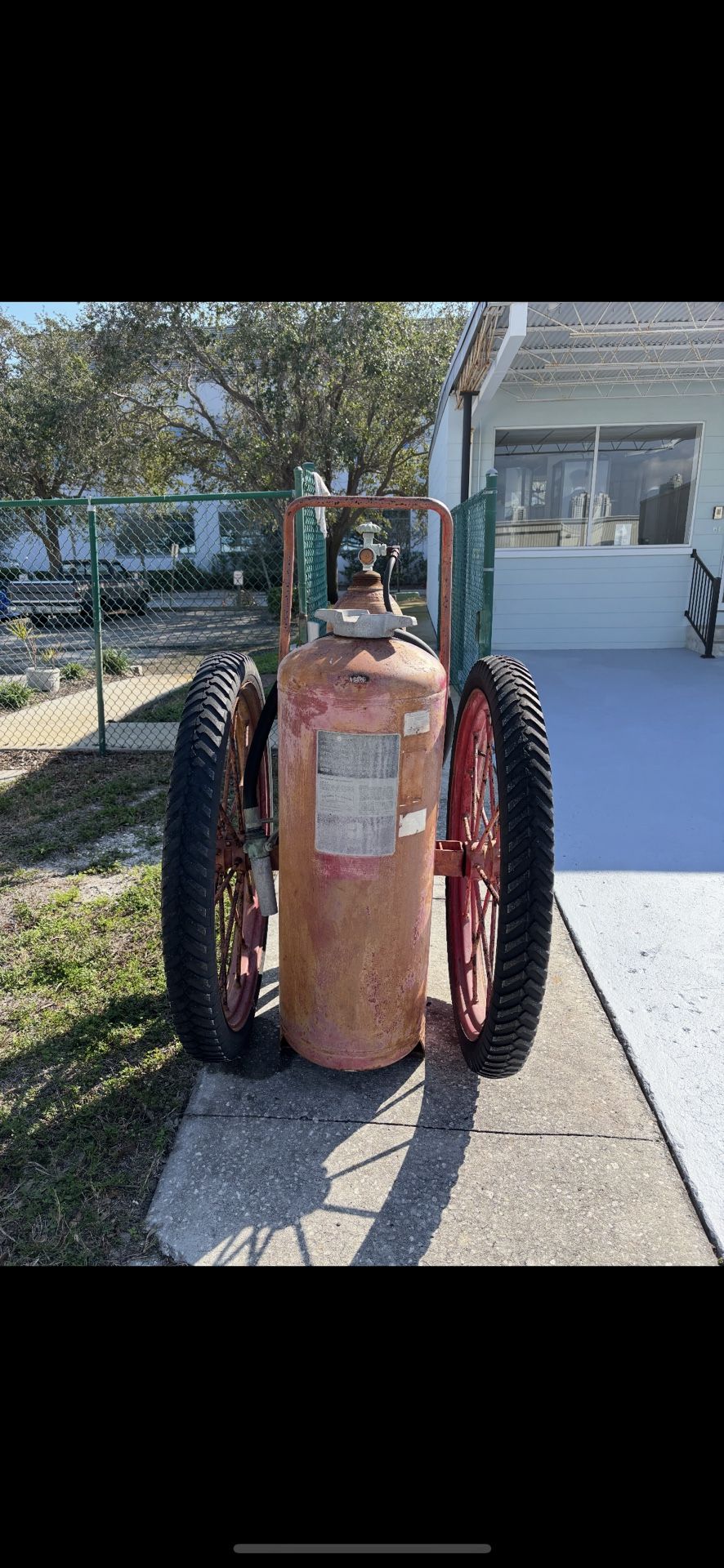 Antique fire extinguisher on wheels
