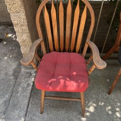 Two Sturdy Wooden Chairs With Red Cushion