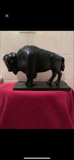 The black, silhouette buffalo statue