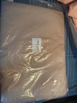 Tan Fabric Item in Sealed Plastic Packaging