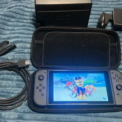 Nintendo switch with docking station, joy, con grip, HDMI, case and paw patrol game