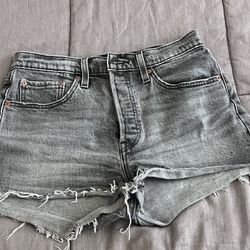 Levi's 501 high-rise denim shorts in a faded black or "lunar black" wash. This