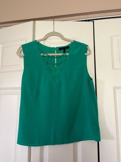 . It’s A Beautiful blouse made by BCBG it’s 100% silk. The color is green. The size is large. It is for women.