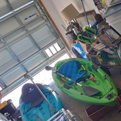 2 kayaks one fishing and one ocean paddles wheels to pull