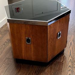 Mid Century Hexagonal Chrome Accent Side Table/ Cabinet. It consist of smoked glass top with chrome trim and hinged door, it rests on a plinth base. I