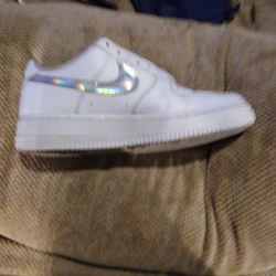 White nike's with metallic sign