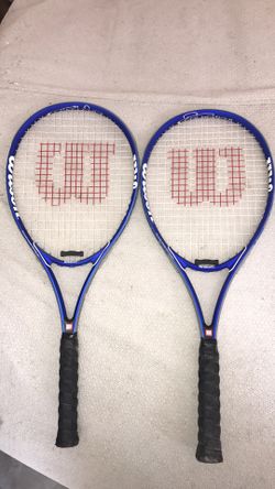 Two blue Wilson lawn tennis rackets