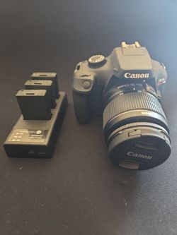 Canon Rebel T100 Camera, lens and 3 x batteries.