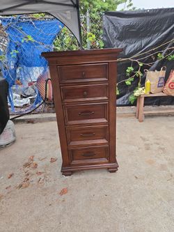 A solid wood 5-drawer dresser in good condition