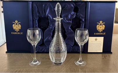 Fabergé crystal drinkware set includes a decanter and two matching stemmed wine glasses, presented in a signature blue velvet box.