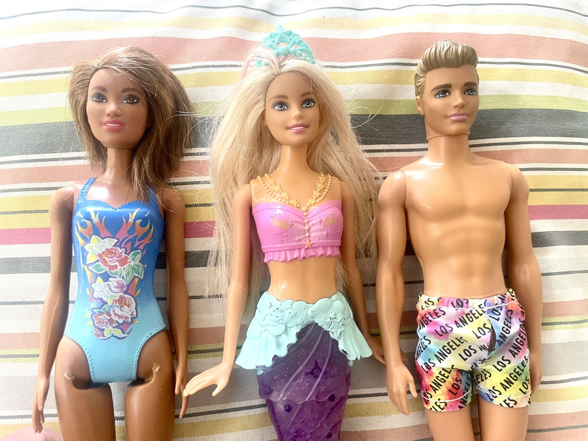 ** 4 Barbie and Ken Dolls **