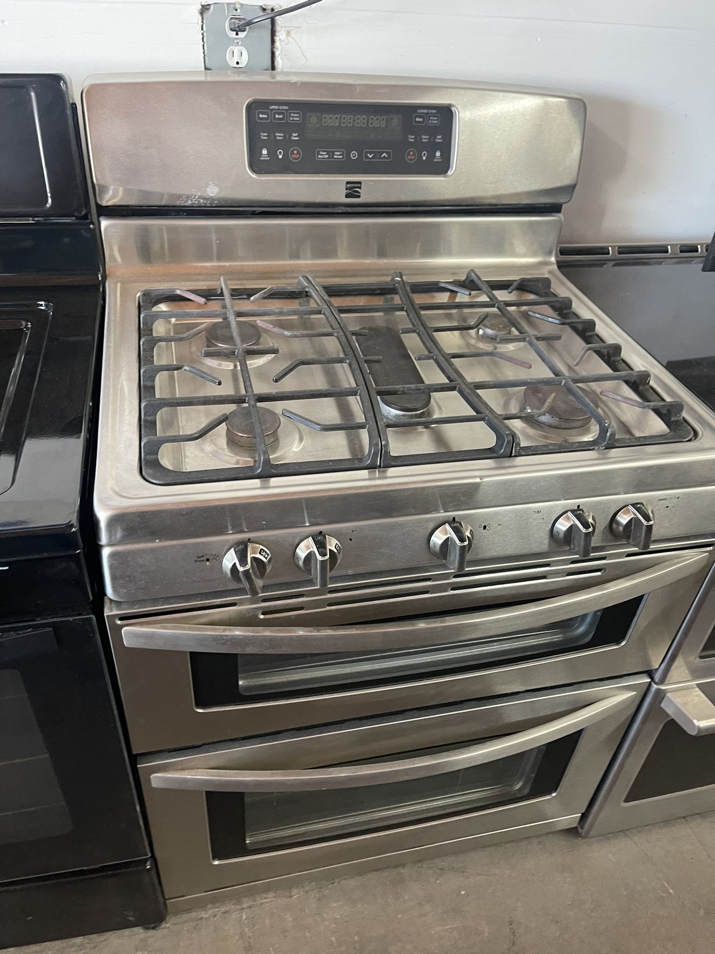 Kenmore, double oven. Gas range comes with 90 day warranty.