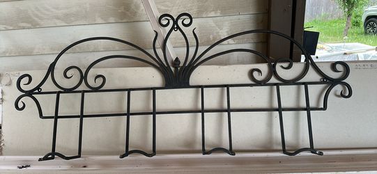 Decirative wrought iron scrollwork wall rack