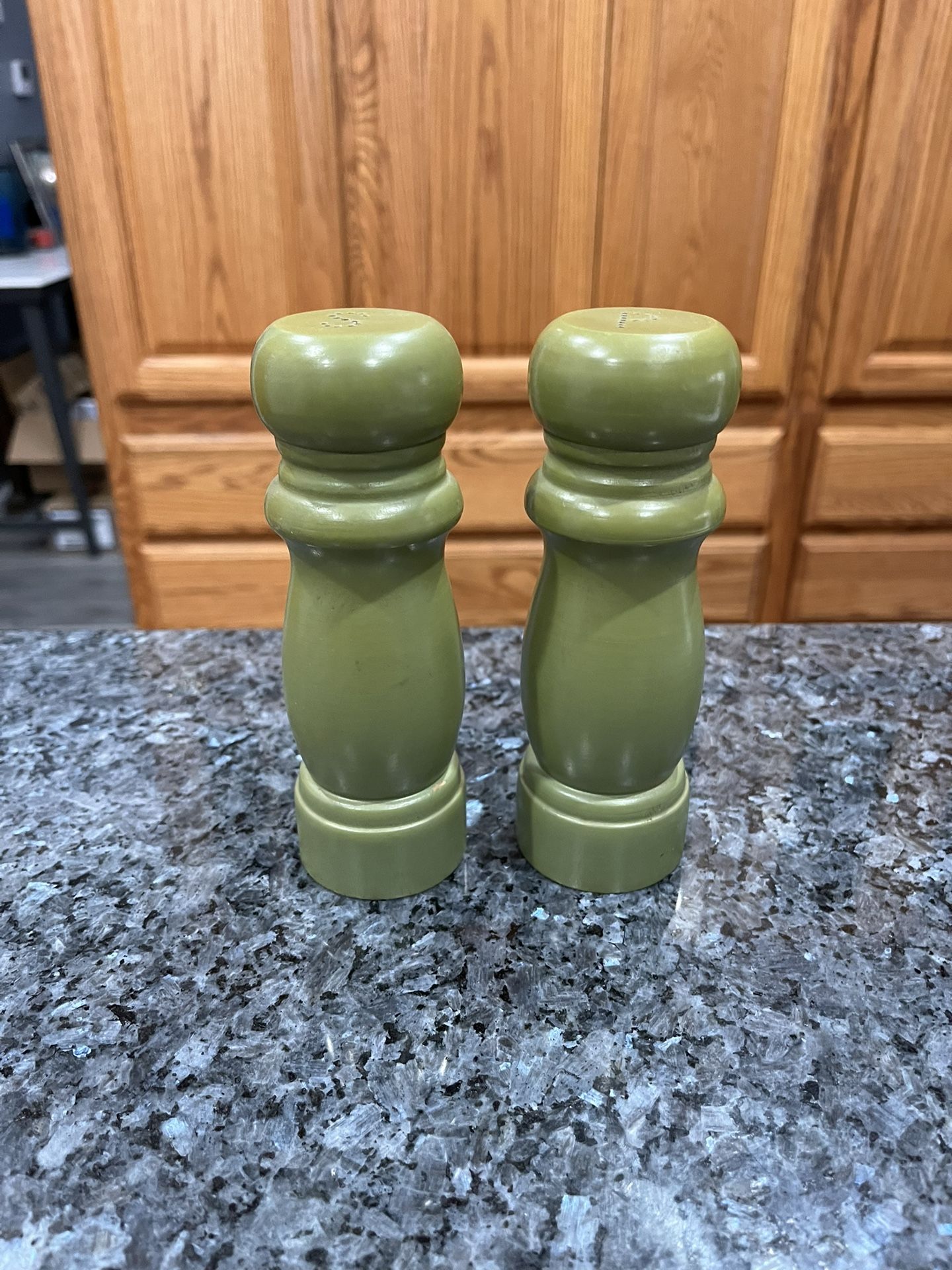 Green Wooden Pair of salt and pepper shakers. Size approximately 6 inches tall. Preowned.