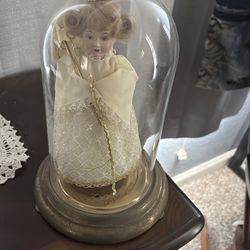 Antique doll in glass