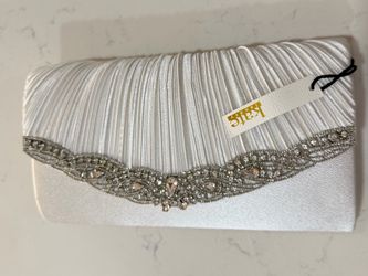Elegant silver clutch with rhinestone detailing by Kate Landry