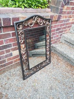 Large dark metal frames mirror