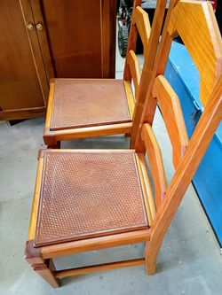 Two wood and leather chairs