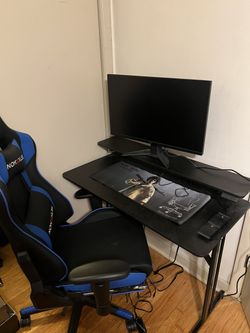 Gaming Setup With MSI Monitor, Desk, And Chair