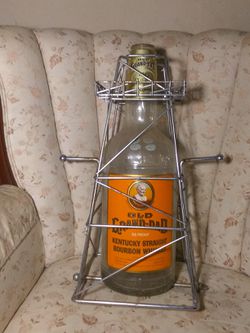 Vintage old grand-dad one gallon bottle on cradle stand