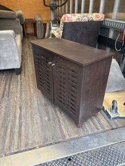 Compact Dark Brown Storage Cabinet with Woven Doors