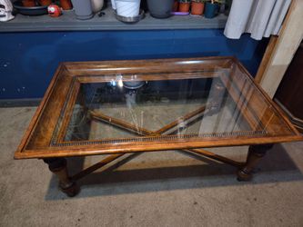 Wooden coffee table with bead trim and x shaped bottom and glass insert on top